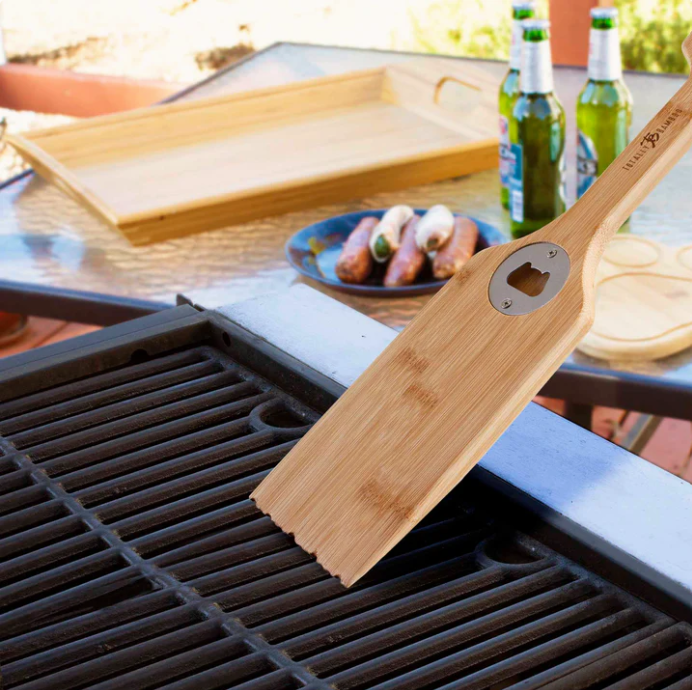 Built-in bottle opener feature on wooden BBQ scraper shown as part of a Texas grilling accessory gift from The Texas Gift Company