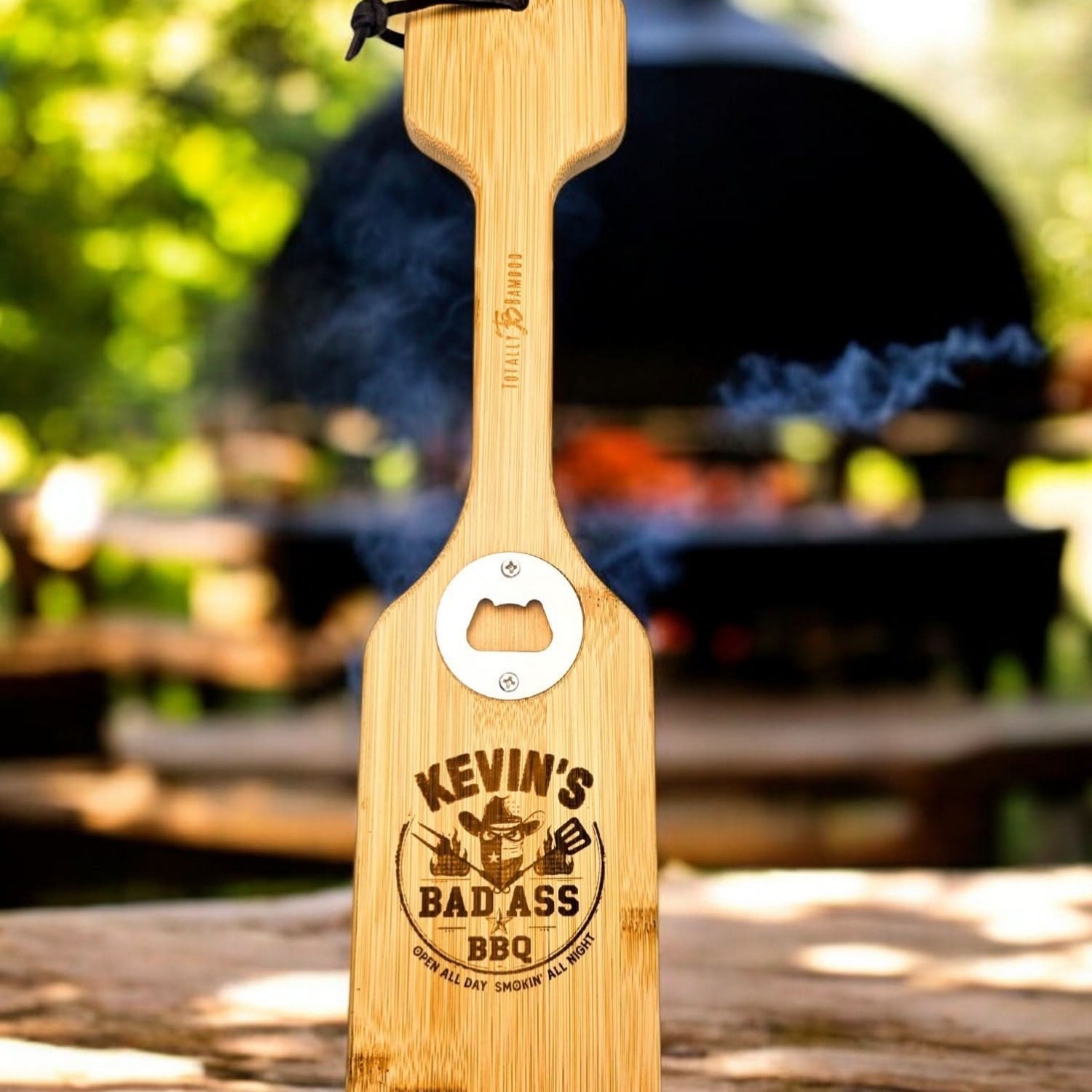 Custom engraved wooden grill scraper with built-in bottle opener displayed as a premium Texas grilling accessory gift from The Texas Gift Company storefront
