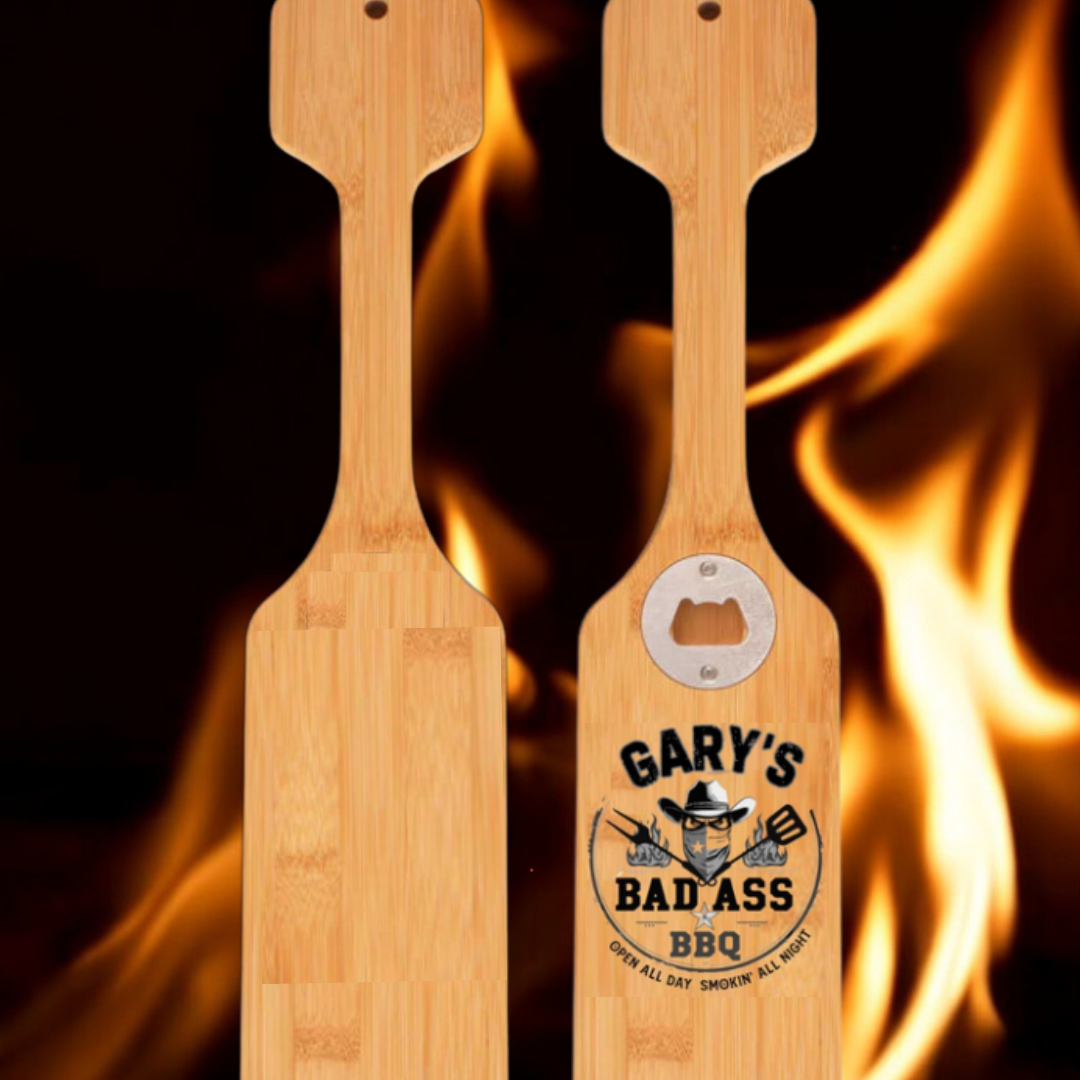 Custom engraved wooden grill scraper with bottle opener displayed as a Texas grilling accessory from The Texas Gift Company storefront
