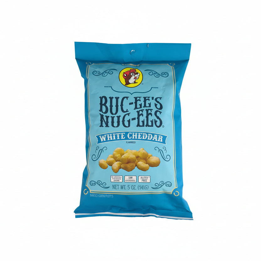 Bag of Buc-ee’s Nug-EEs white cheddar flavored baked corn puffs in a blue package, shown front-facing on a white rustic wooden background with product branding and size clearly visible.