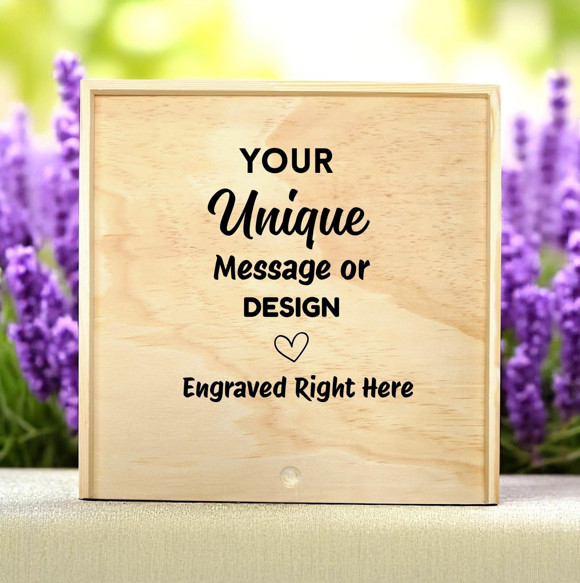 Wooden keepsake box displayed with the text “Your Unique Message or Design Engraved Right Here,” shown against a soft lavender floral background to highlight custom engraving and personalization options.
