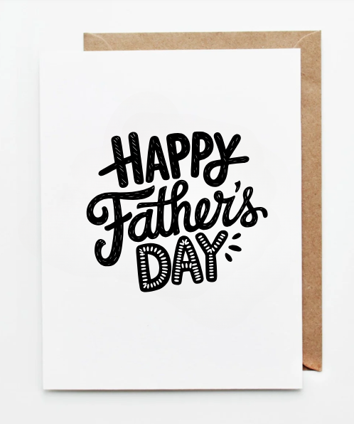 White Father’s Day greeting card with ‘Happy Father’s Day’ written in modern blue and gold lettering, accented with stars, shown with a kraft paper envelope