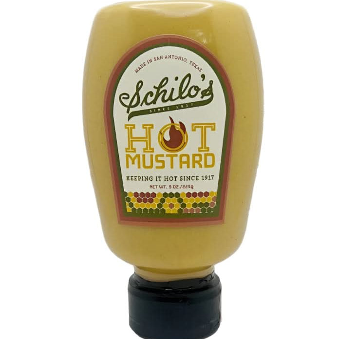 Squeeze bottle of Schilo’s hot mustard made in San Antonio, Texas, featuring a yellow bottle with a vintage-style label and black flip-top cap, displayed on a white background.