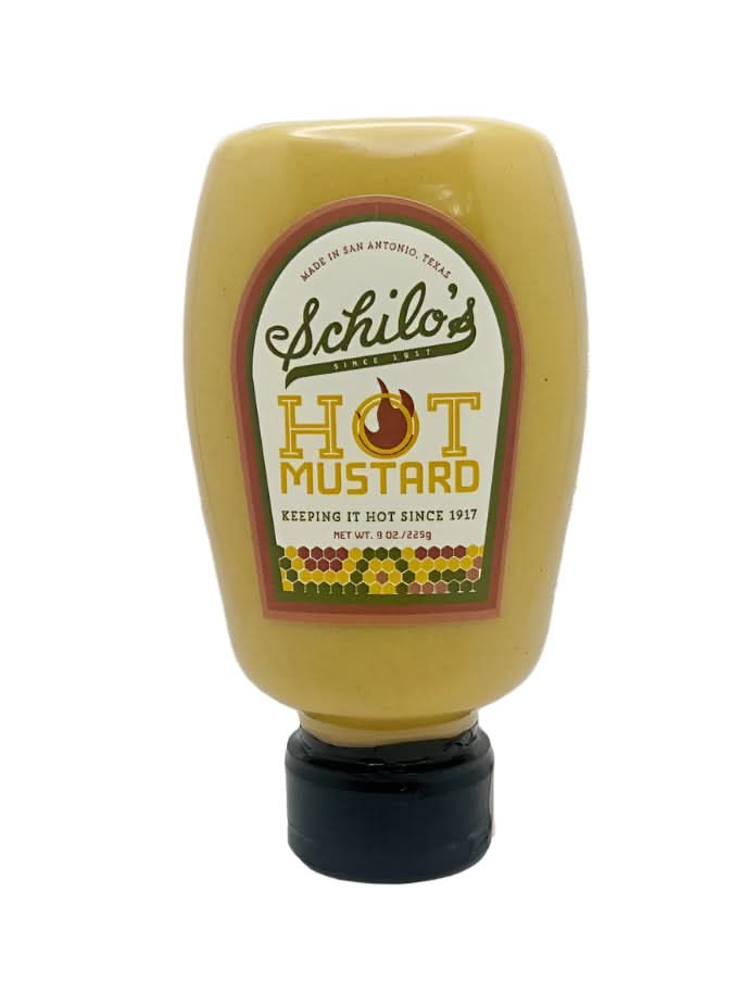 Squeeze bottle of Schilo’s hot mustard made in San Antonio, Texas, featuring a yellow bottle with a vintage-style label and black flip-top cap, displayed on a white background.