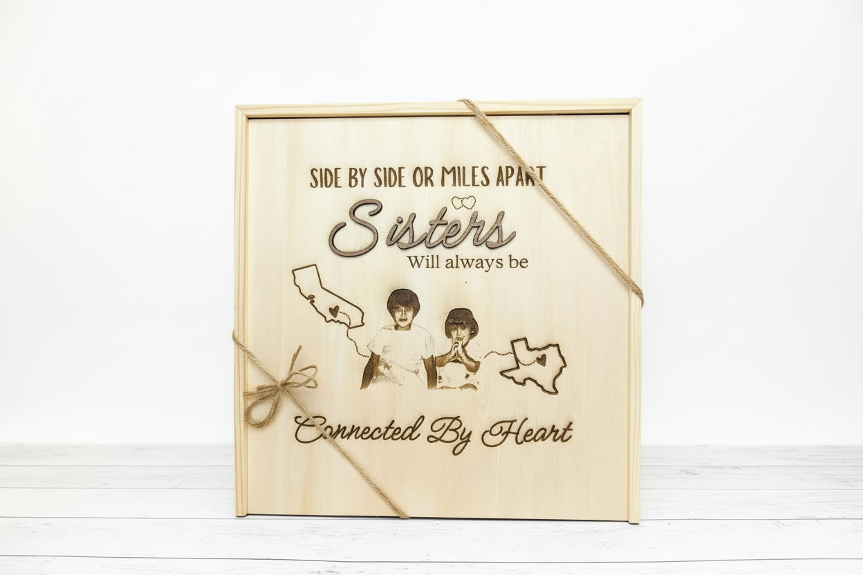 Personalized wooden keepsake box engraved with the phrase “Side by side or miles apart, sisters will always be connected by heart,” featuring a custom photo engraving, state outlines, and twine accents symbolizing long-distance sisterhood.
