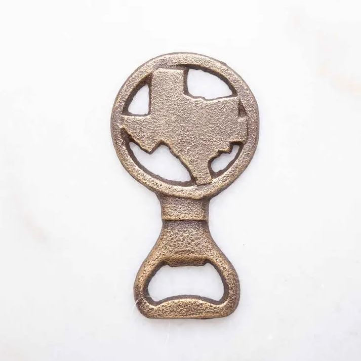 Antique gold Texas-shaped bottle opener displayed as a rustic Texas bar accessory gift from The Texas Gift Company storefront