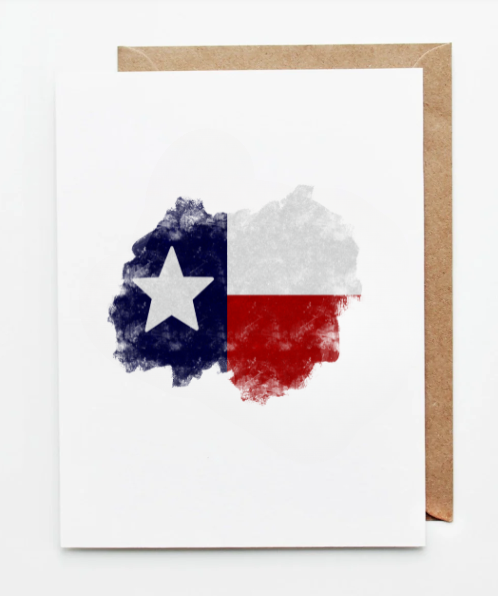 White greeting card featuring a watercolor-style Texas state silhouette filled with the Texas flag colors and lone star, displayed with a kraft paper envelope