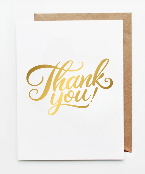 White greeting card featuring elegant gold calligraphy text reading ‘Thank you!’ paired with a kraft paper envelope