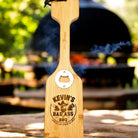 Custom engraved wooden grill scraper with built-in bottle opener displayed as a premium Texas grilling accessory gift from The Texas Gift Company storefront
