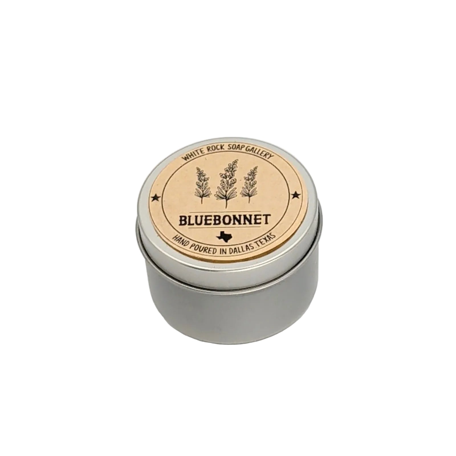 Silver metal tin bluebonnet scented candle by White Rock Soap Gallery, featuring bluebonnet flower illustrations on the lid and labeled hand poured in Dallas, Texas, displayed on a white background.