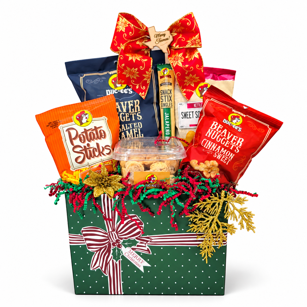 Buc-ee’s All Wrapped Up Christmas Box with six snacks, festive bow and green gift box on white
