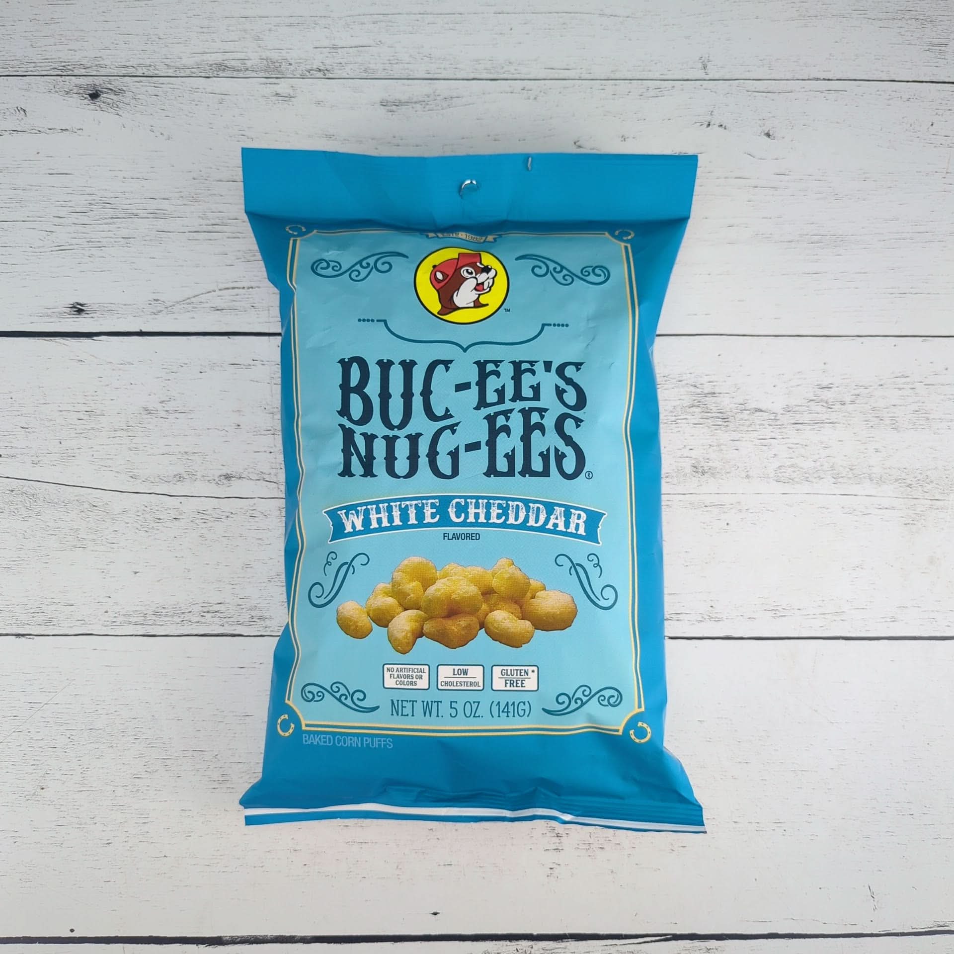 Buc-ee’s Nug-ees white cheddar corn puffs packaged as a savory Texas snack gift from The Texas Gift Company storefront