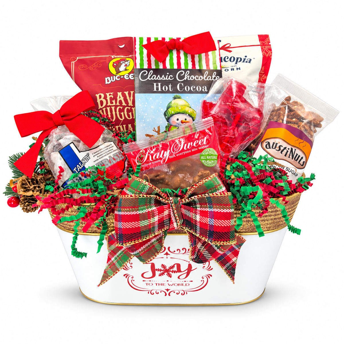 Cocoa & Christmas Cheer with seven snack and cocoa products in a Joy to the World metal container, plaid bow and Christmas greenery on white