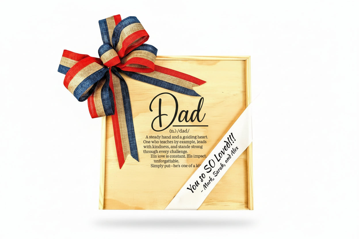 Personalized wooden gift box engraved with a “Dad” definition and heartfelt message, decorated with a red, blue, and gold ribbon bow and a custom message ribbon reading “You So Loved,” presented as a meaningful Father’s Day keepsake.