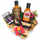 Texas Christmas Cookout, a Christmas selection of barbecue sauce, glaze, beef seasoning, chili mix and a Texas bottle opener in a Texas-shaped basket on white.