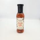 Fischer & Wieser Peaches & Whiskey BBQ Sauce in a glass bottle with a black cap, displayed on a white background for Texas gourmet food gifts and barbecue collections