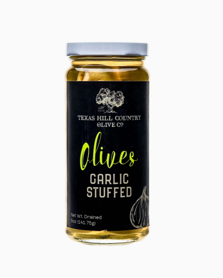 Garlic stuffed olives jar displayed as a gourmet Texas food and entertaining gift from The Texas Gift Company storefront
