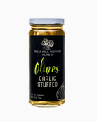 Garlic stuffed olives jar displayed as a gourmet Texas food and entertaining gift from The Texas Gift Company storefront