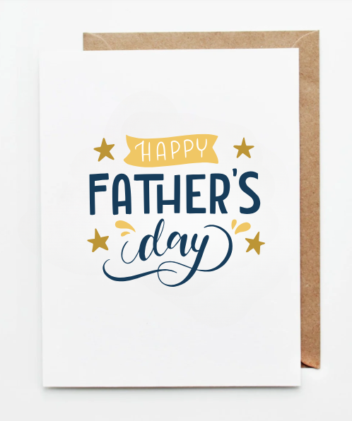 White Father’s Day greeting card with ‘Happy Father’s Day’ written in modern blue and gold lettering, accented with stars, shown with a kraft paper envelope