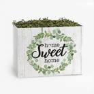 Rustic home sweet home gift box with green foliage wreath design filled with green shredded paper