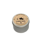 Silver metal tin candle labeled “Ranch Hand” by White Rock Soap Gallery, featuring a cowboy on horseback illustration and hand poured in Dallas, Texas, photographed on a white background.