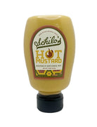 Squeeze bottle of Schilo’s hot mustard made in San Antonio, Texas, featuring a yellow bottle with a vintage-style label and black flip-top cap, displayed on a white background.