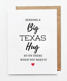 “White greeting card with the message ‘Sending a Big Texas Hug so it’s there when you need it,’ featuring modern typography and a small red heart, paired with a kraft paper envelope.”
