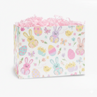 Pastel spring bunny and Easter egg patterned gift box filled with pink shredded paper