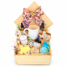 The Pampered Cowgirl wooden spa gift box with pink western bow, Texas mug, bath and body products, floral Texas keepsake box and wooden scoop on a white background.