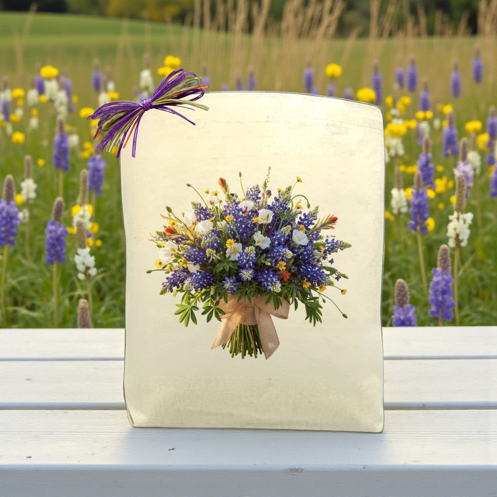 Cream-colored gift bag featuring a rustic wildflower bouquet illustration with a meadow background