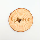 Wooden circular coaster with 'home' engraved on a white background, with a Texas silhouette